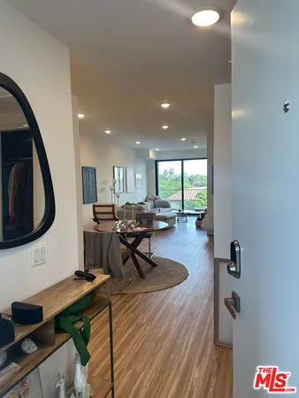 a living room with furniture a rug and a large window