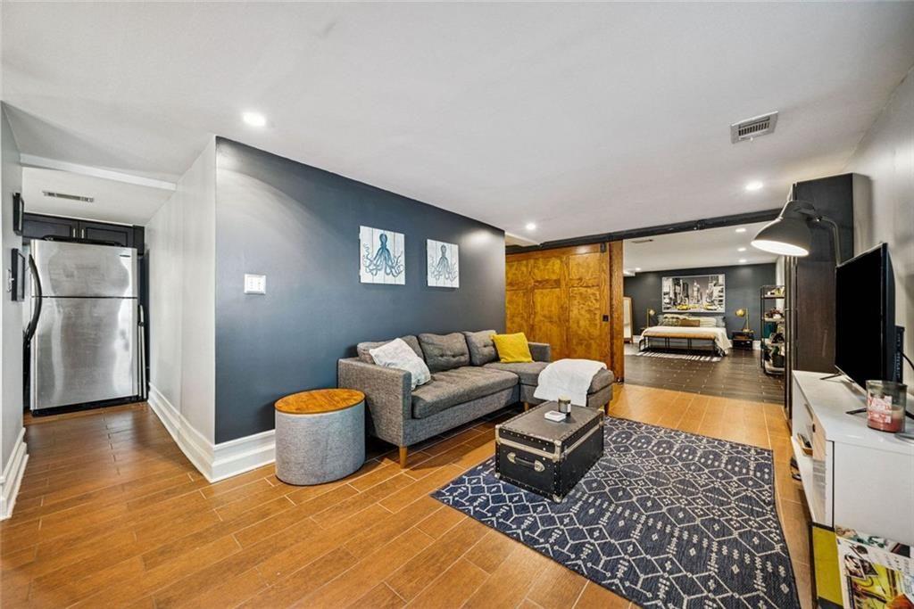 3048 Briarcliff Road Northeast, Unit 9 Atlanta, GA 30329 - Photo 11 of 30 a living room with furniture and a flat screen tv