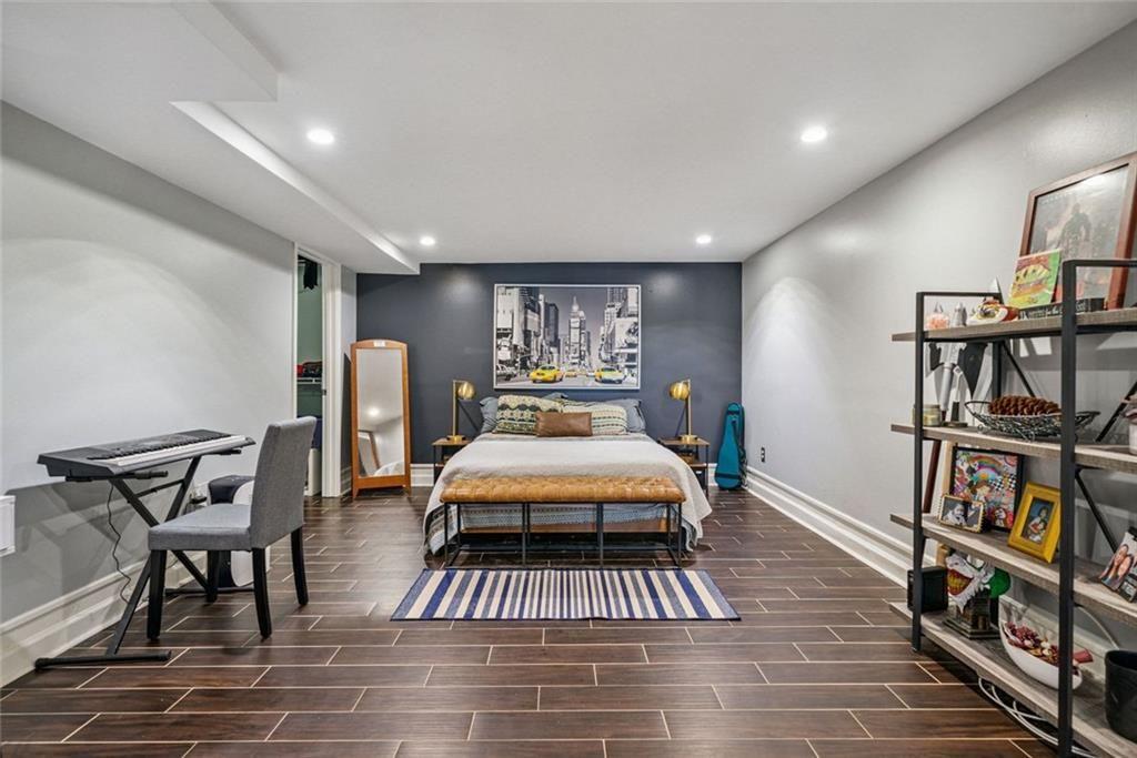 3048 Briarcliff Road Northeast, Unit 9 Atlanta, GA 30329 - Photo 15 of 30 a living room with furniture a rug and a book shelf