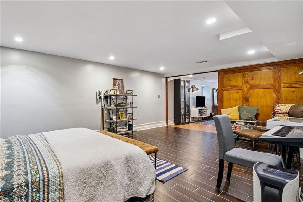 3048 Briarcliff Road Northeast, Unit 9 Atlanta, GA 30329 - Photo 17 of 30 a bedroom with furniture and a wooden floor
