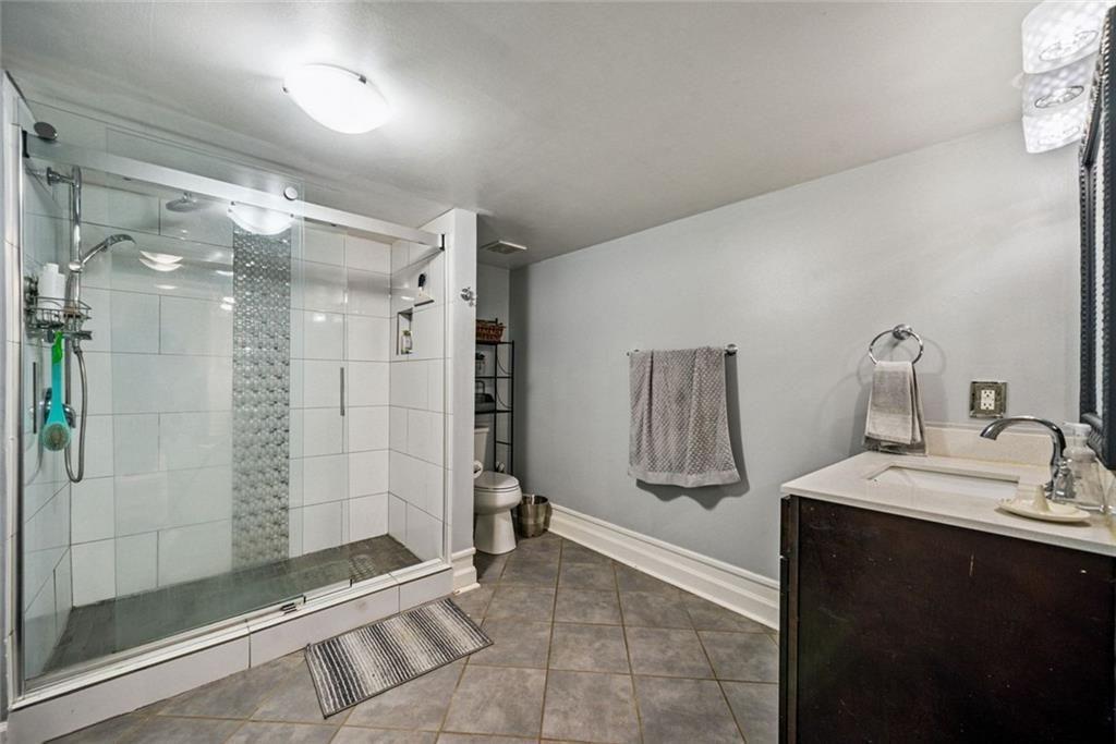 3048 Briarcliff Road Northeast, Unit 9 Atlanta, GA 30329 - Photo 20 of 30 a bathroom with a shower sink and mirror