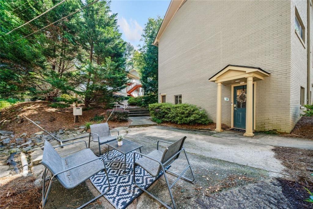 3048 Briarcliff Road Northeast, Unit 9 Atlanta, GA 30329 - Photo 23 of 30 a view of a patio with table and chairs and potted plants