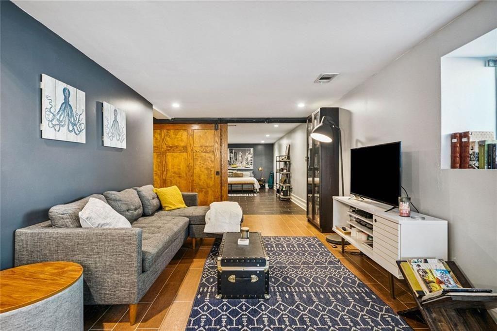 3048 Briarcliff Road Northeast, Unit 9 Atlanta, GA 30329 - Photo 10 of 30 a living room with furniture and a flat screen tv