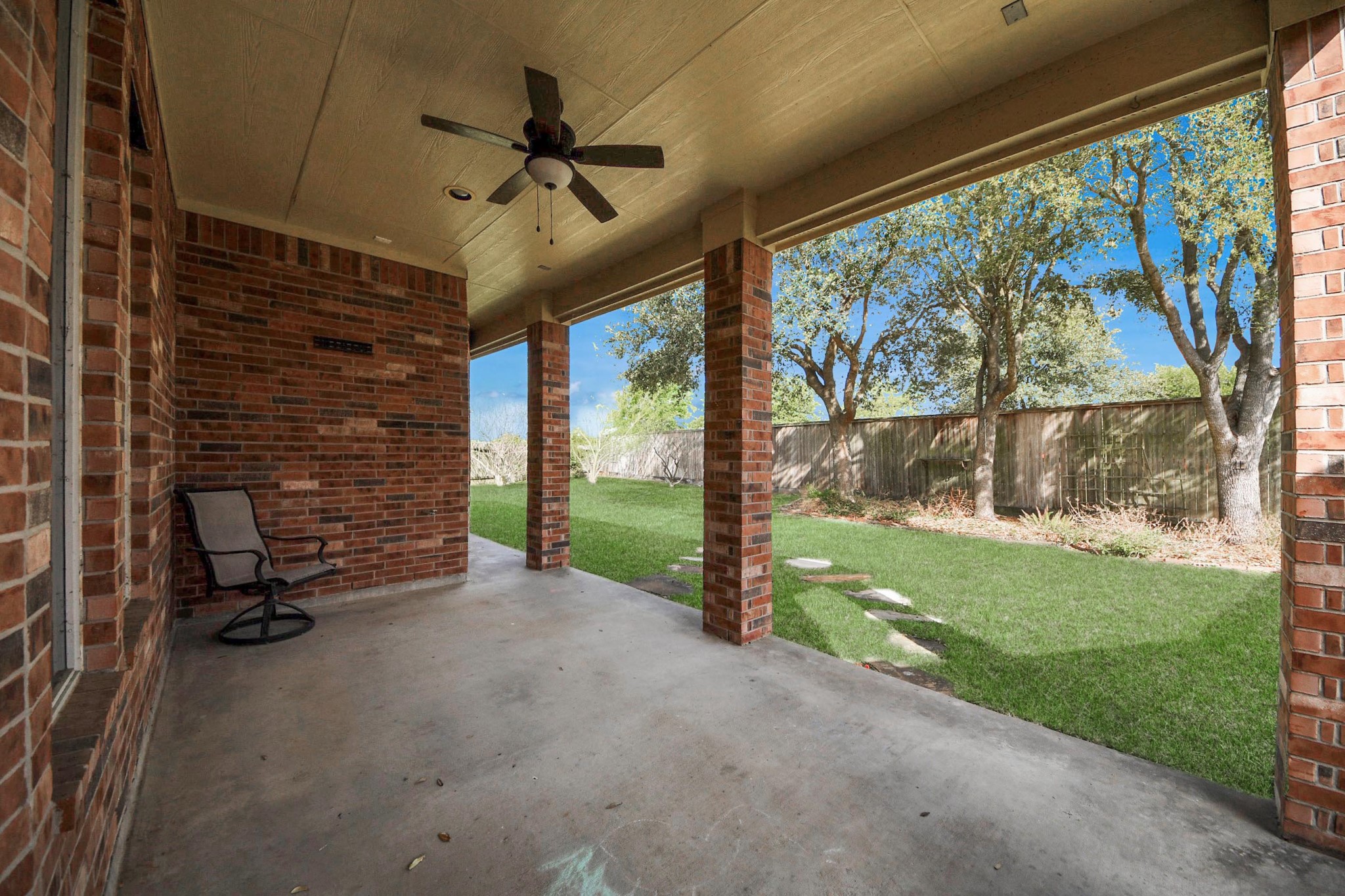 17618 Raven Canyon Lane Houston, TX 77095 - Photo 35 of 45 Enjoy this inviting covered patio area, ideal for relaxing or entertaining, overlooking the beautifully maintained backyard.