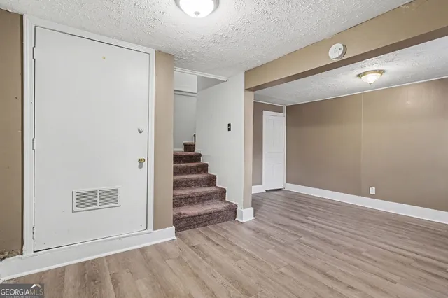 a view of an entryway with wooden floor