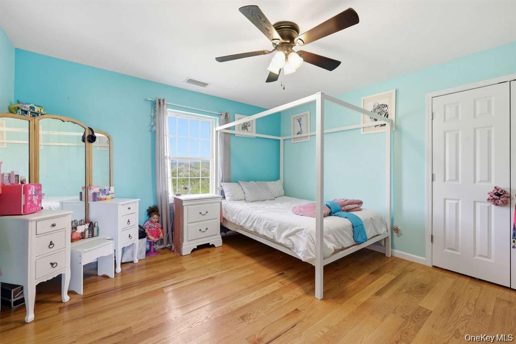 133 Old Chester Road Goshen, NY 10924 - Photo 21 of 33 a bedroom with a bed and a chandelier