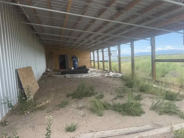 a view of an empty room with a fireplace and a large window