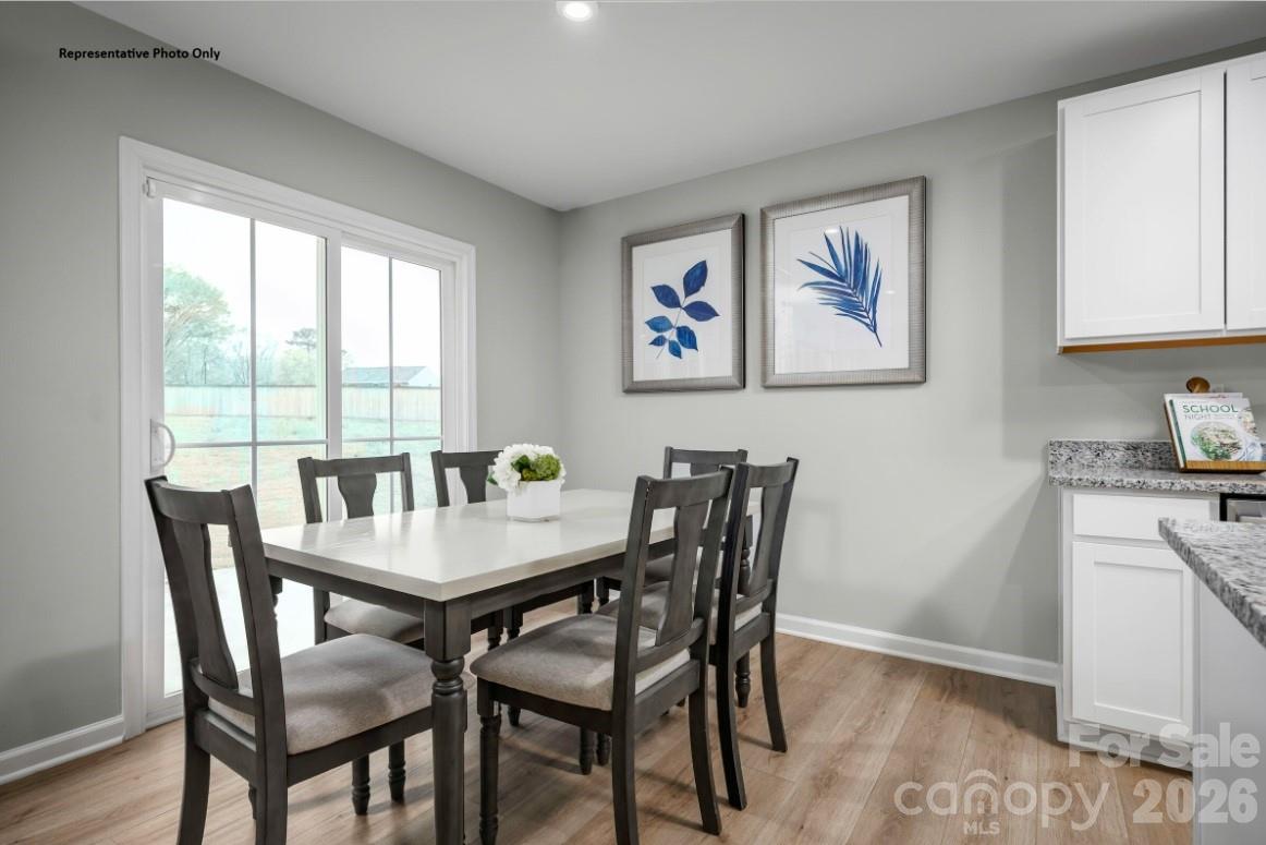 162 Basildon Street, Unit 1064 Lancaster, SC 29720 - Photo 5 of 10 a view of a dining room with furniture and a window