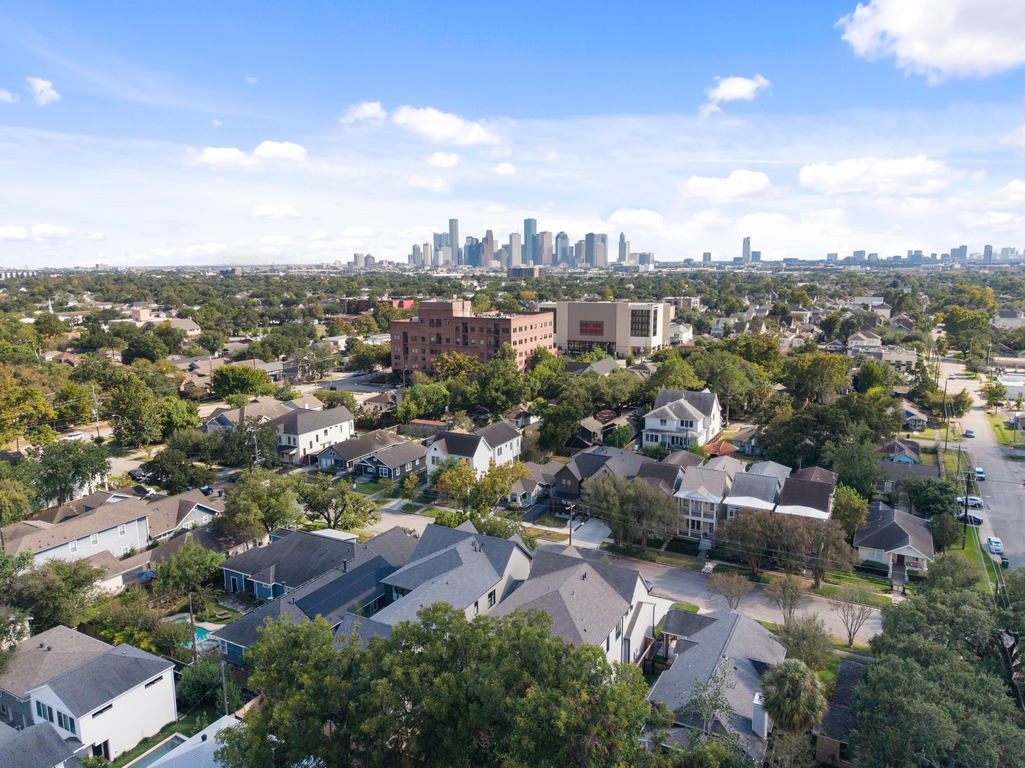 711 East 12th Street Houston, TX 77008 - Photo 46 of 47 A neighborhood perspective captures the appeal of Heights living: tree-lined streets, distinctive homes, and Houston’s skyline on the horizon. At 711 E 12th, neighborhood charm and city connection come together.