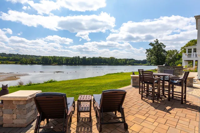 a view of a swimming pool and outdoor seating