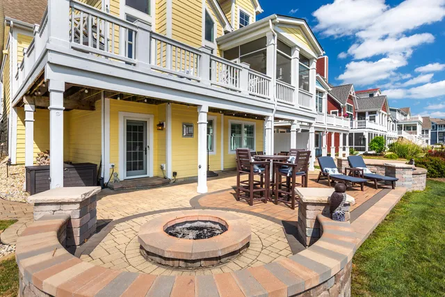 a view of a patio with dining table and chairs with a floor to ceiling window