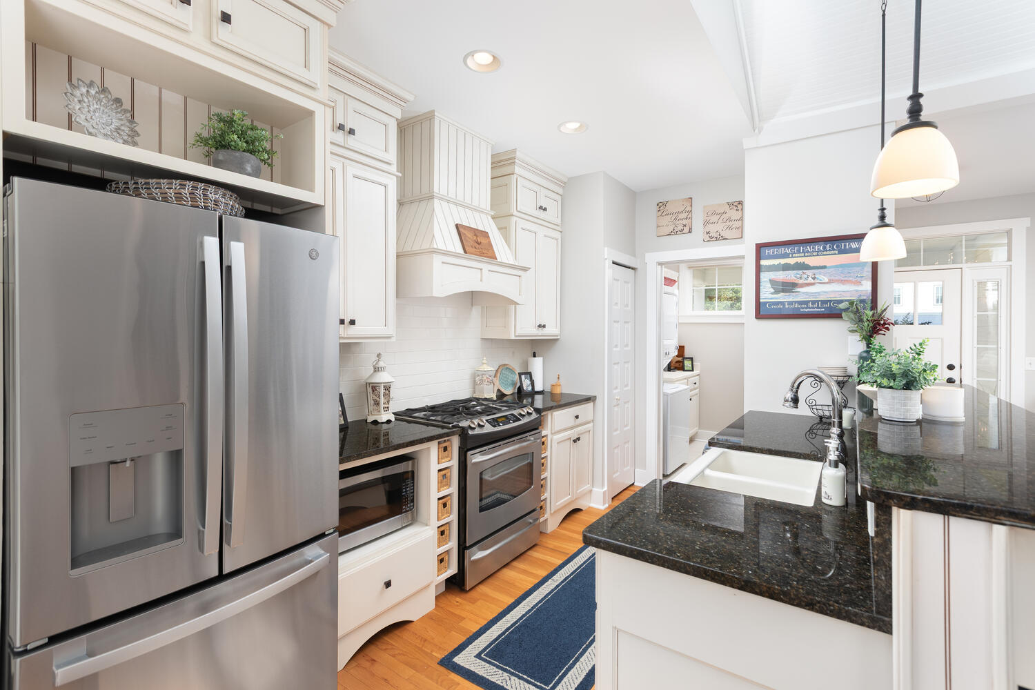 5 Windward Way Ottawa, IL 61350 - Photo 27 of 50 a kitchen with stainless steel appliances granite countertop a refrigerator a stove and a sink with wooden floor