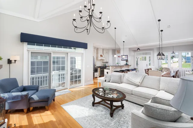 a living room with furniture wooden floor and a large window