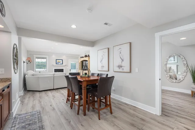 a dining room with furniture and wooden floor