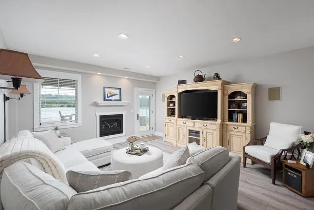 a living room with furniture fireplace and flat screen tv