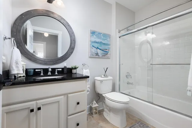 a bathroom with a toilet a sink and a mirror