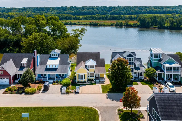 an outdoor living area with furniture and a lake view
