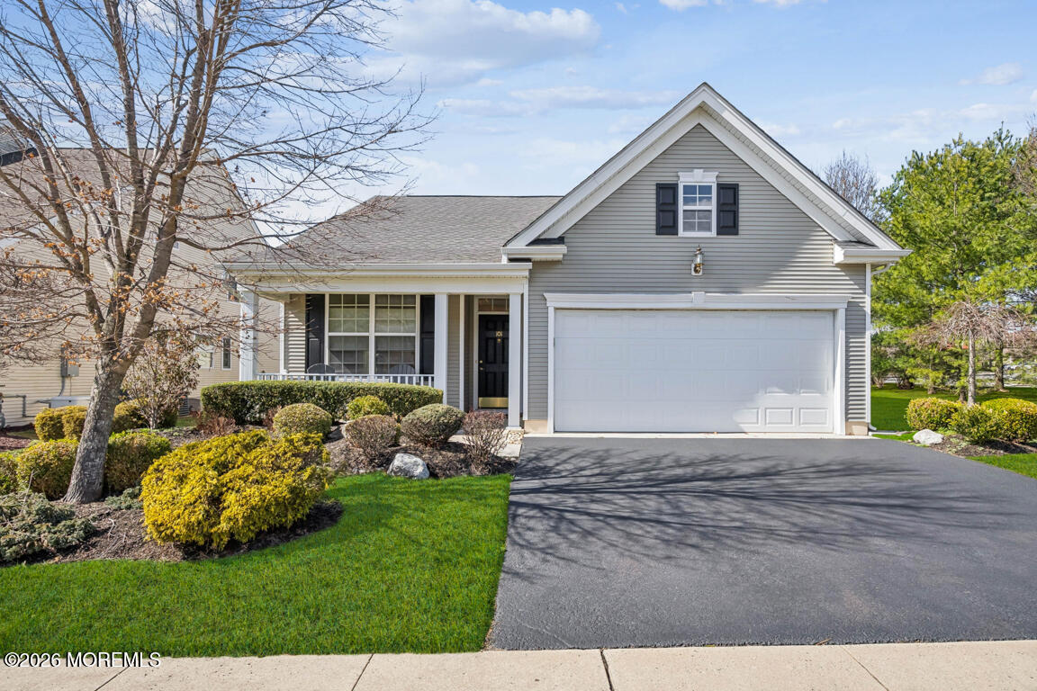 a front view of a house with a garden and yard