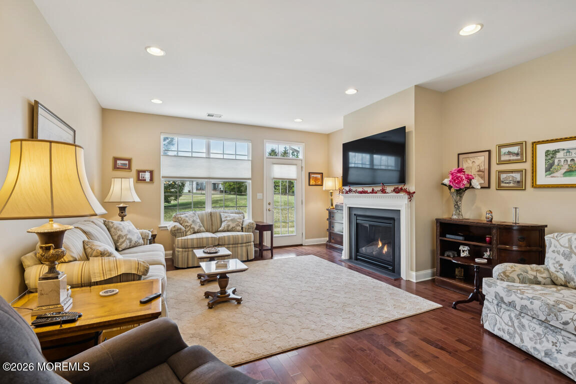 101 Nottingham Way Jackson, NJ 08527 - Photo 11 of 31 a living room with furniture a fireplace and a flat screen tv
