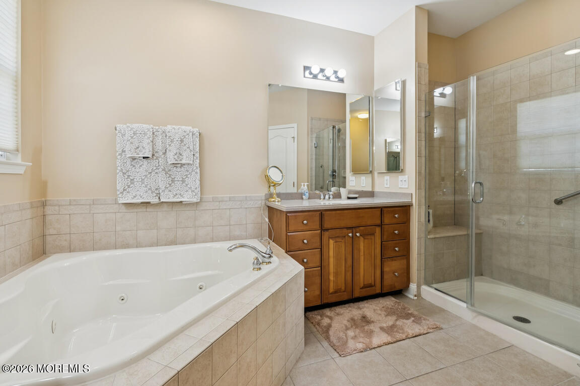 101 Nottingham Way Jackson, NJ 08527 - Photo 16 of 31 a bathroom with a tub a sink shower and mirror