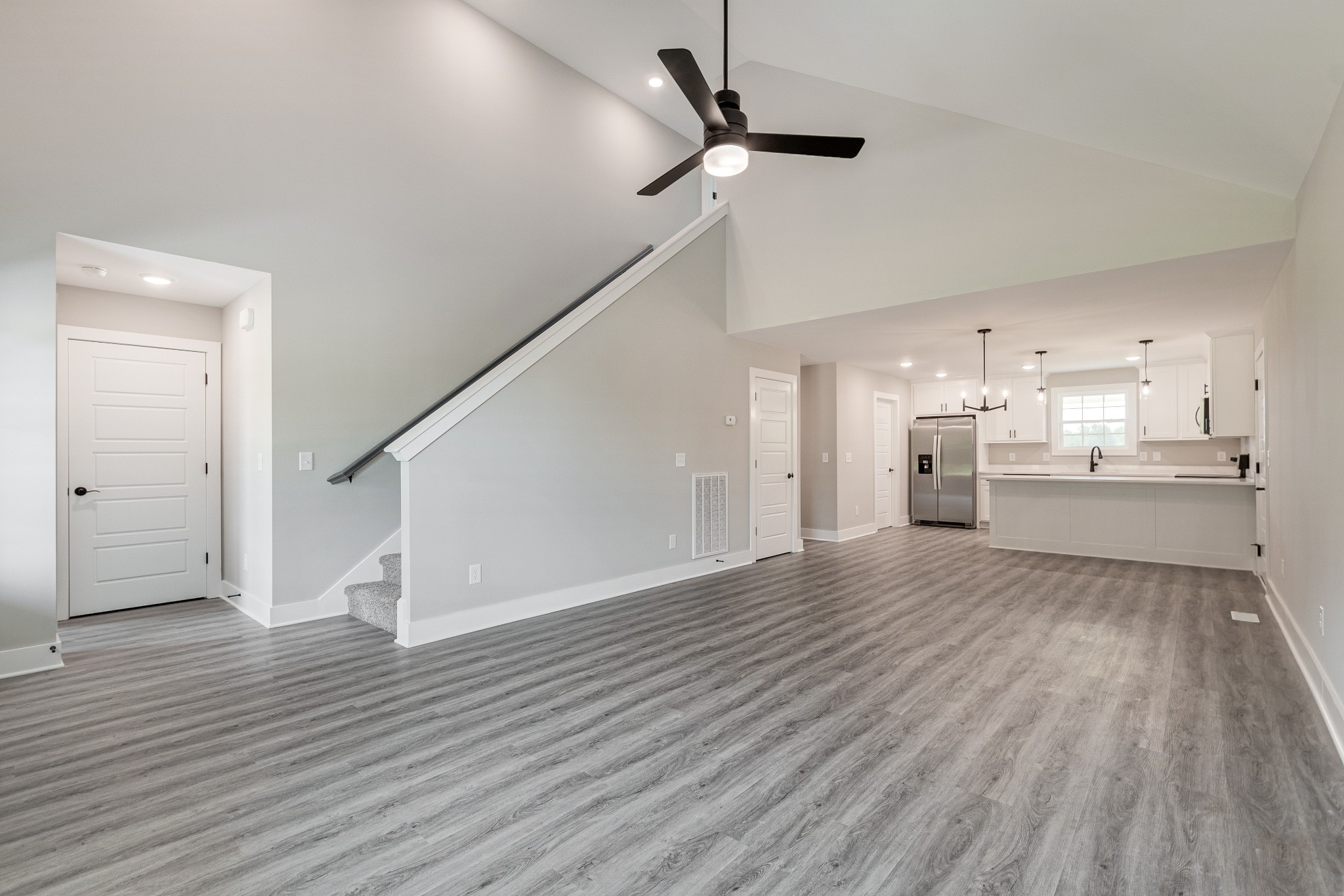 916 Butler Bridge Road Portland, TN 37148 - Photo 8 of 26 a view of a kitchen with wooden floor and a ceiling fan