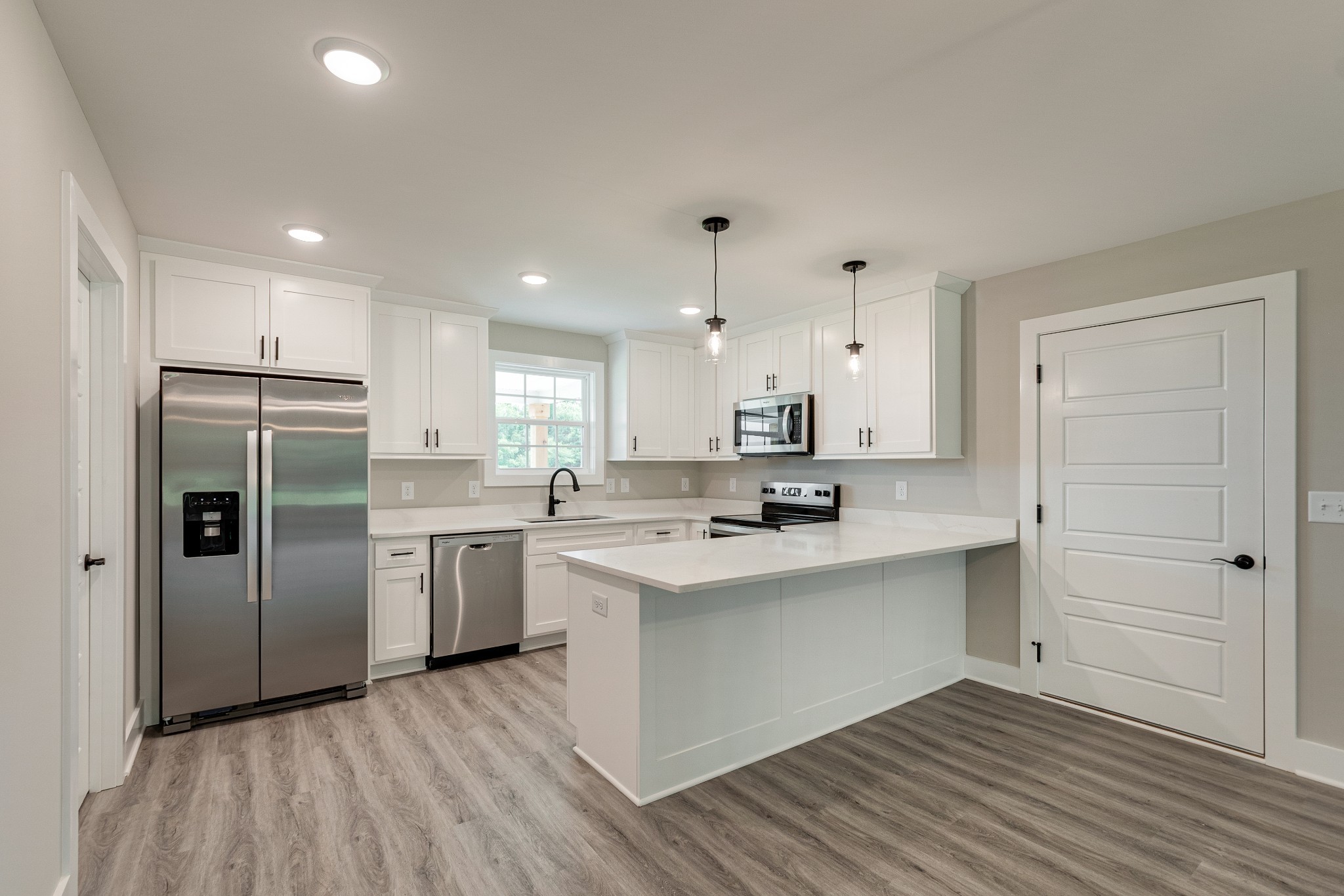 916 Butler Bridge Road Portland, TN 37148 - Photo 10 of 26 a kitchen with white cabinets and stainless steel appliances