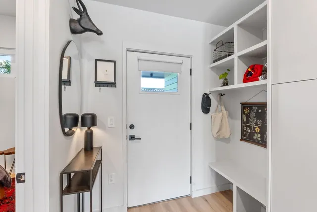 a view of entryway and hall with wooden floor