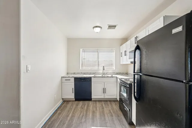 a kitchen with a refrigerator a sink and dishwasher
