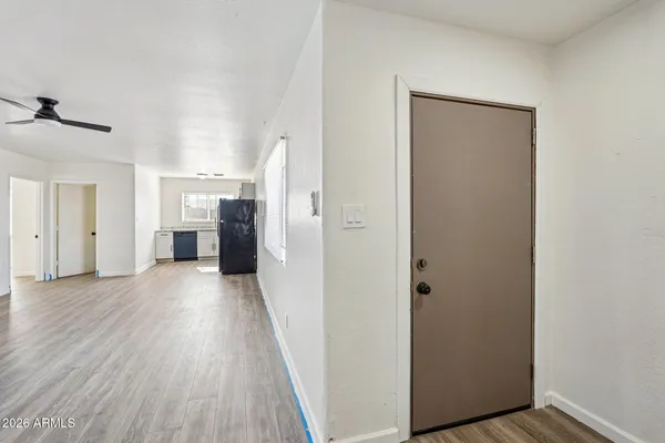 a view of a house with wooden floor and a refrigerator