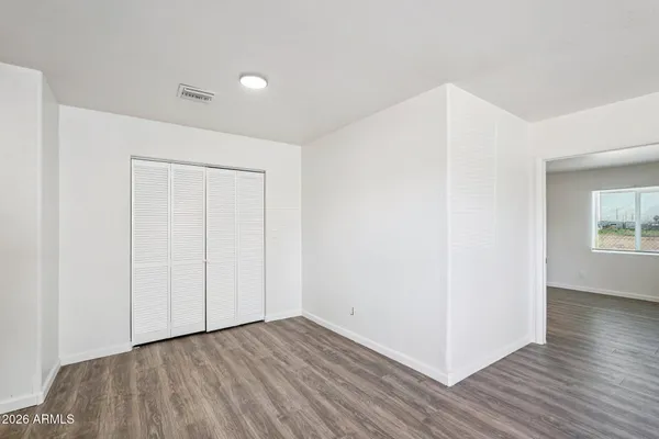 a view of a house with wooden floor and a refrigerator