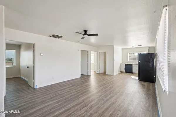 wooden floor in an empty room with a window