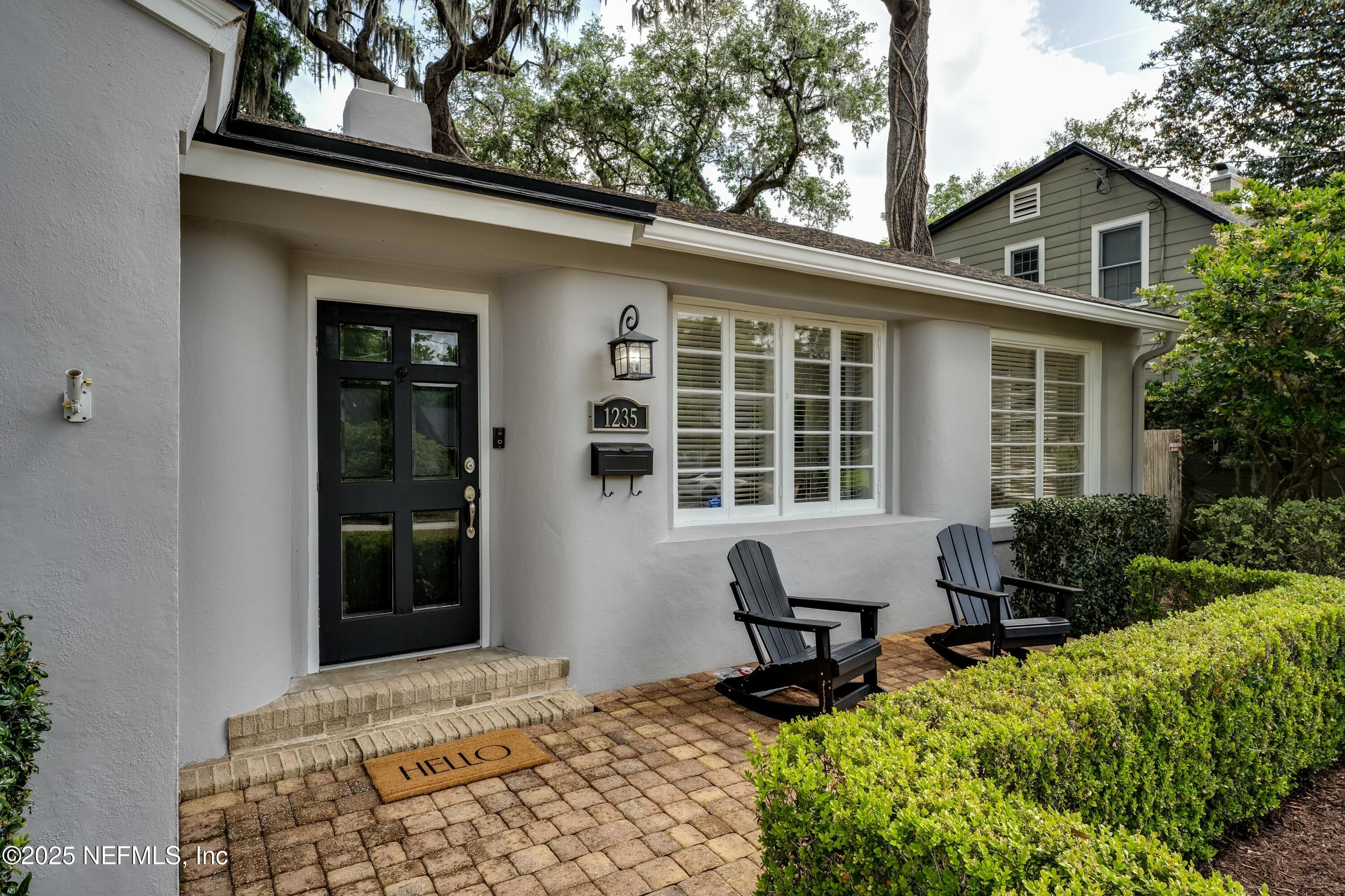 1235 Morvenwood Road Jacksonville, FL 32207 - Photo 1 of 55 a front view of a house with outdoor seating