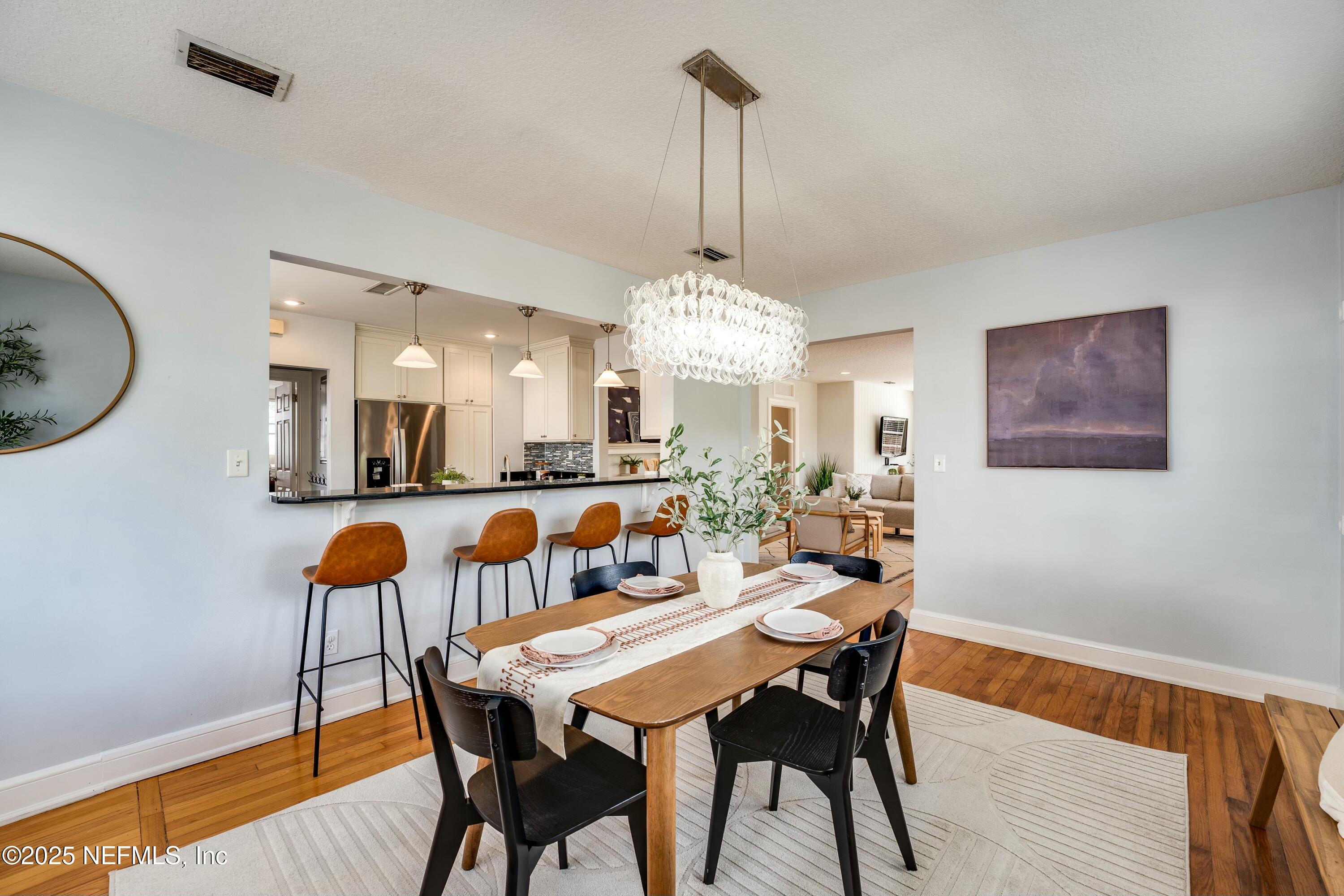 1235 Morvenwood Road Jacksonville, FL 32207 - Photo 16 of 55 a view of a dining room with furniture and wooden floor