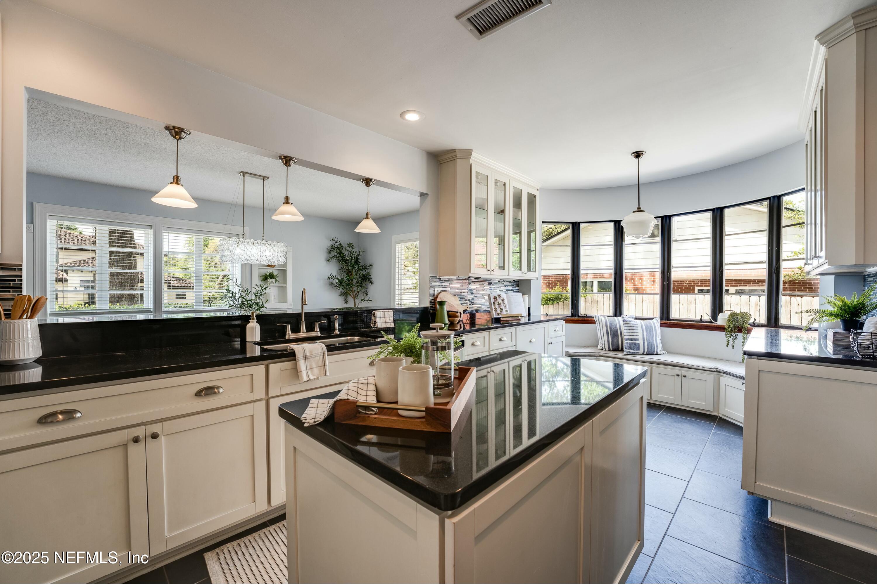 1235 Morvenwood Road Jacksonville, FL 32207 - Photo 20 of 55 a kitchen with counter top space appliances and windows