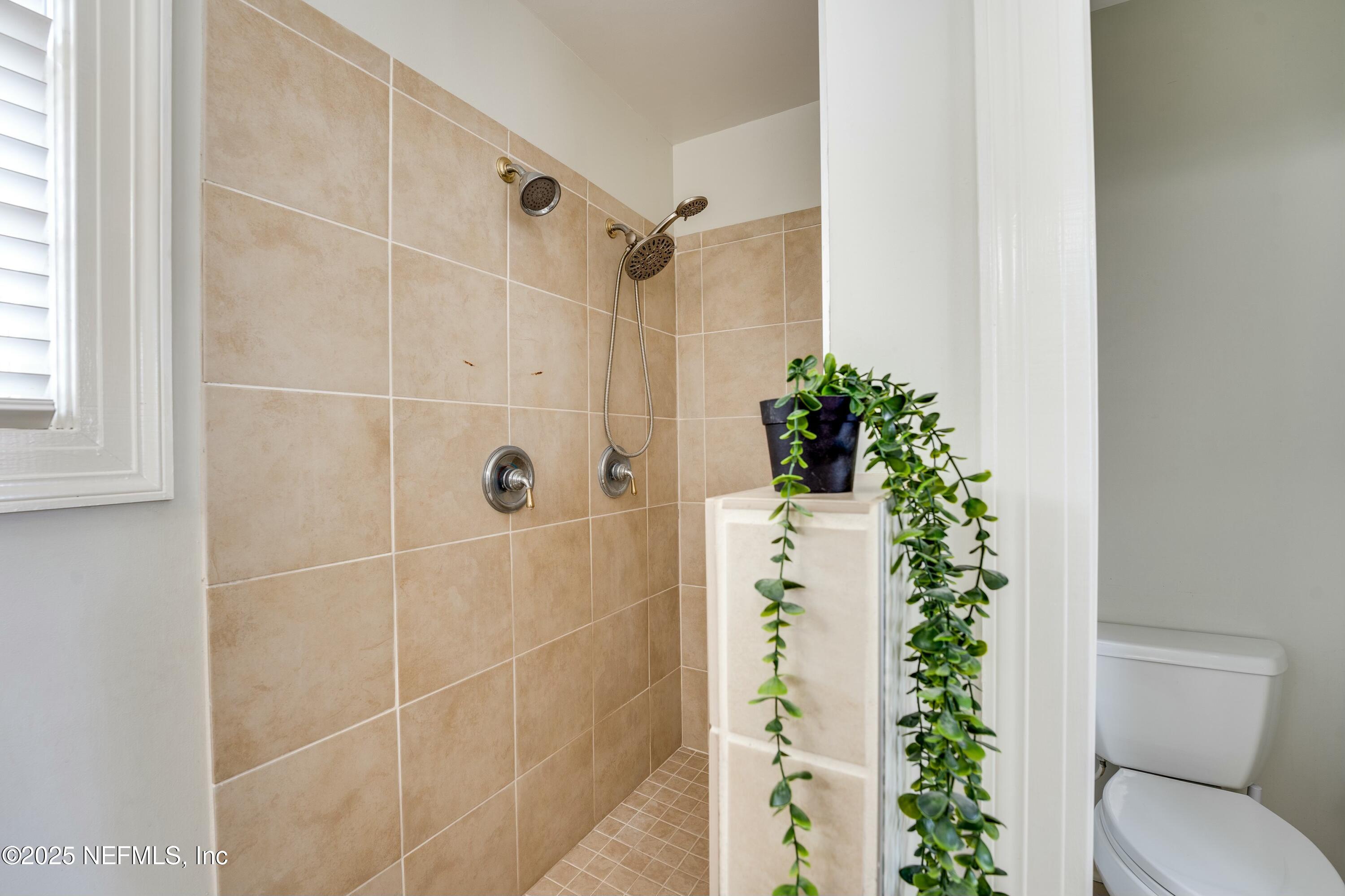 1235 Morvenwood Road Jacksonville, FL 32207 - Photo 27 of 55 a bathroom with a shower curtain and a toilet