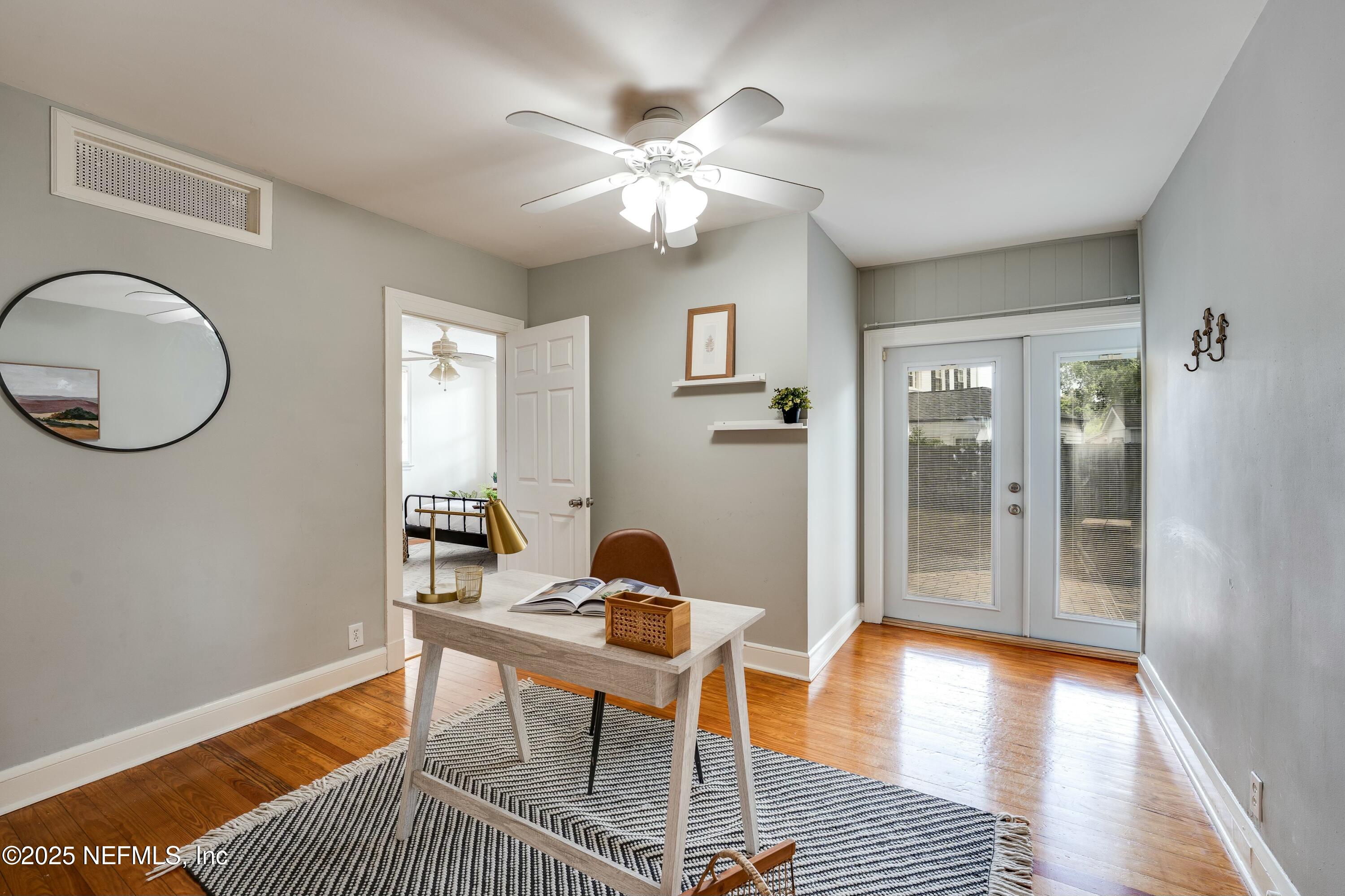 1235 Morvenwood Road Jacksonville, FL 32207 - Photo 28 of 55 a workspace with wooden floor and a chandelier fan