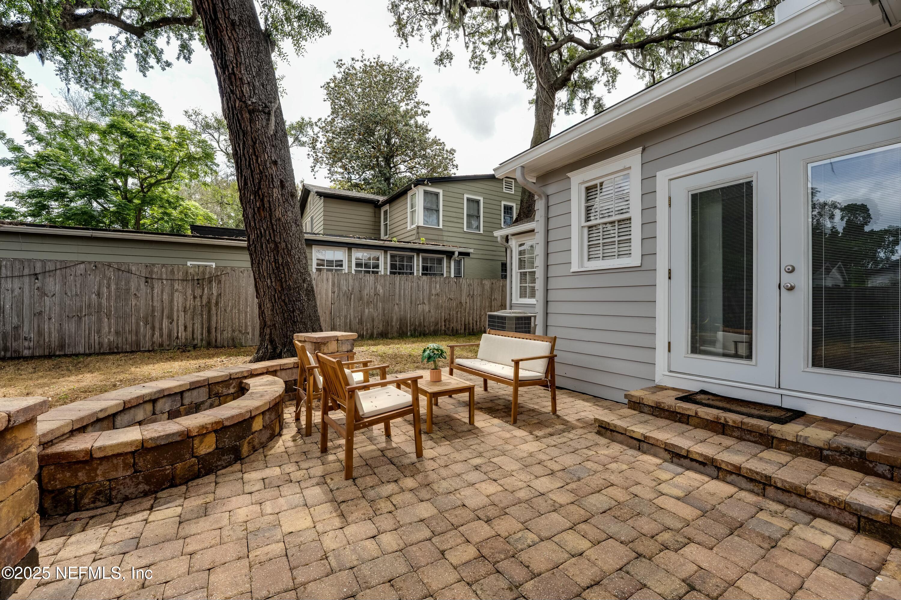 1235 Morvenwood Road Jacksonville, FL 32207 - Photo 36 of 55 a backyard of a house with barbeque oven table and chairs