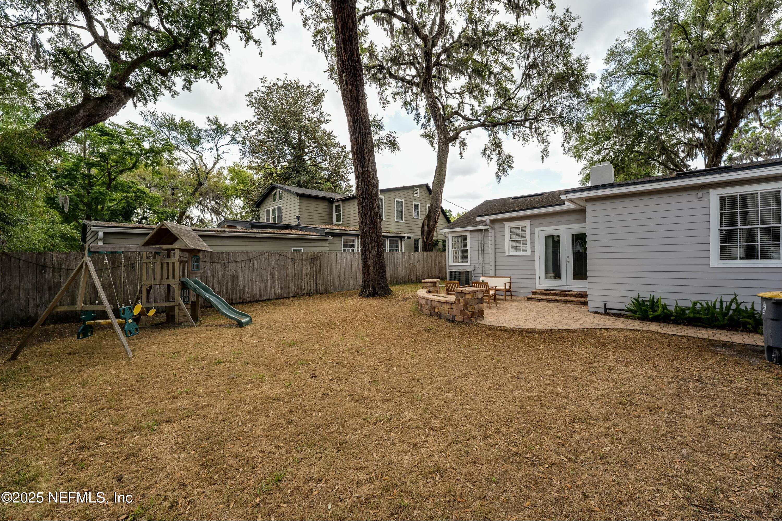 1235 Morvenwood Road Jacksonville, FL 32207 - Photo 37 of 55 a view of a backyard with table and chairs under an trees