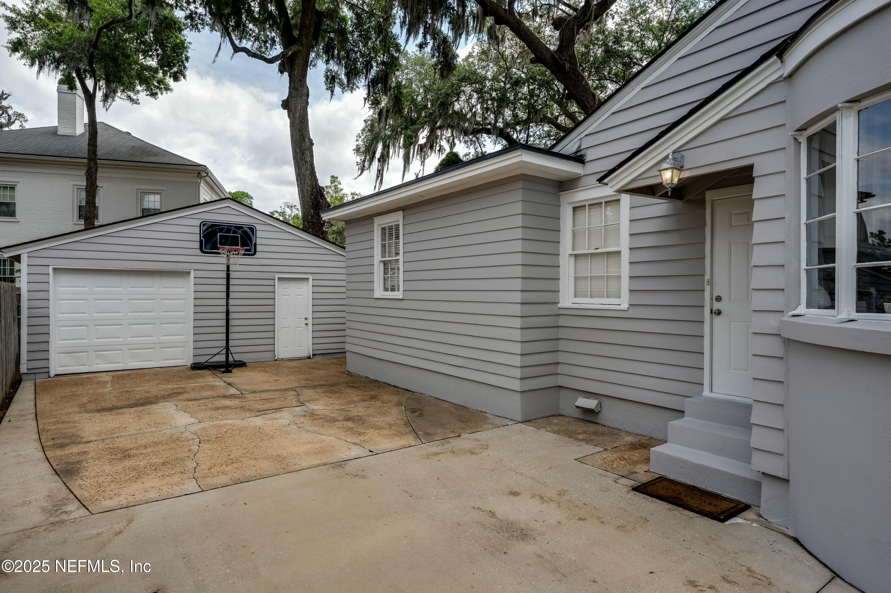 1235 Morvenwood Road Jacksonville, FL 32207 - Photo 40 of 55 a view of a house with a yard and garage