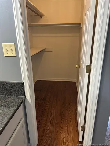 a view of a room with wooden floor and a window
