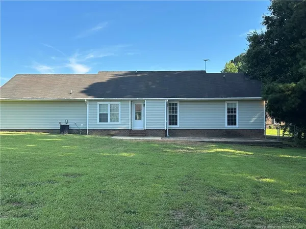 a view of a house with a backyard
