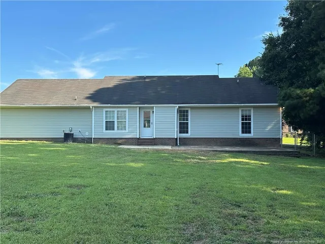 a view of a house with a backyard