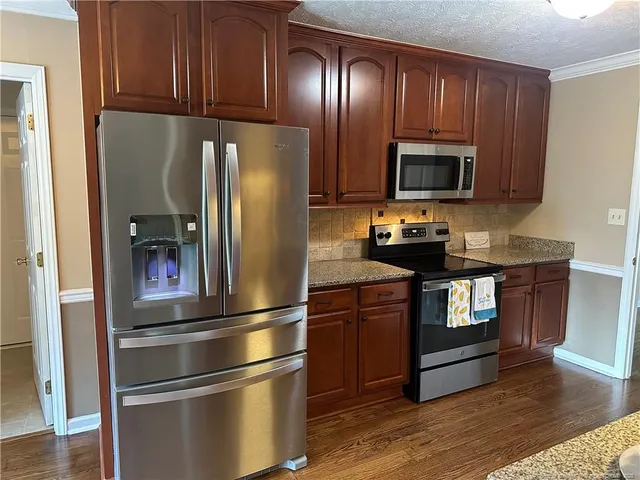 a bathroom with granite countertop cabinets and sink