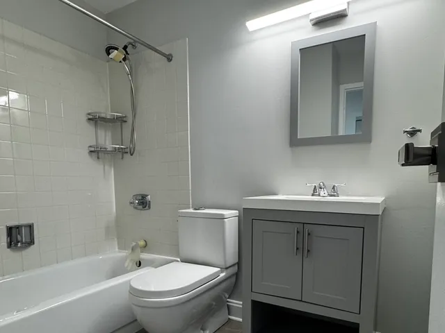 a bathroom with a sink toilet and shower