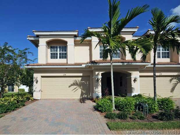 134 Southwest Walking Path Stuart, FL 34997 - Photo 2 of 25 Exterior Front. Stunning End Unit Townhome with brick paver driveway, sidewalk and covered entry. Large 2 car garage. This home has it all!!