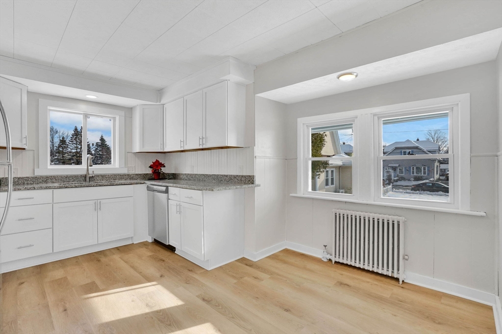 12 Stebbins Street Chicopee, MA 01020 - Photo 11 of 39 a kitchen with white cabinets and window