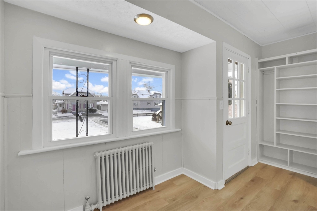 12 Stebbins Street Chicopee, MA 01020 - Photo 12 of 39 a view of an empty room with wooden floor and a window
