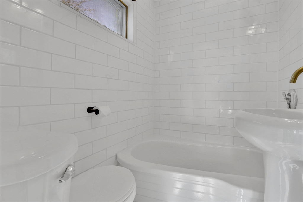12 Stebbins Street Chicopee, MA 01020 - Photo 24 of 39 a bathroom with a bathtub and toilet