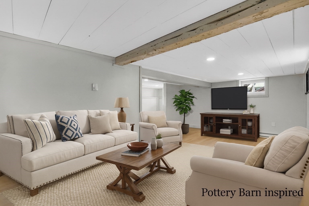 12 Stebbins Street Chicopee, MA 01020 - Photo 25 of 39 a living room with furniture a flat screen tv and a fireplace