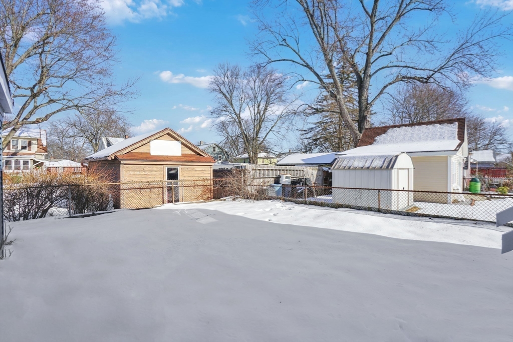12 Stebbins Street Chicopee, MA 01020 - Photo 38 of 39 a view of a house with a yard covered in snow